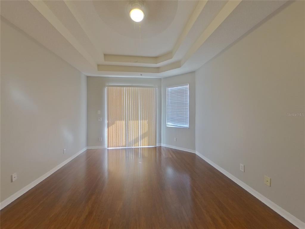 Undisclosed Address Valrico, FL 33596 - Photo 6 of 16 a view of an empty room with wooden floor and a window