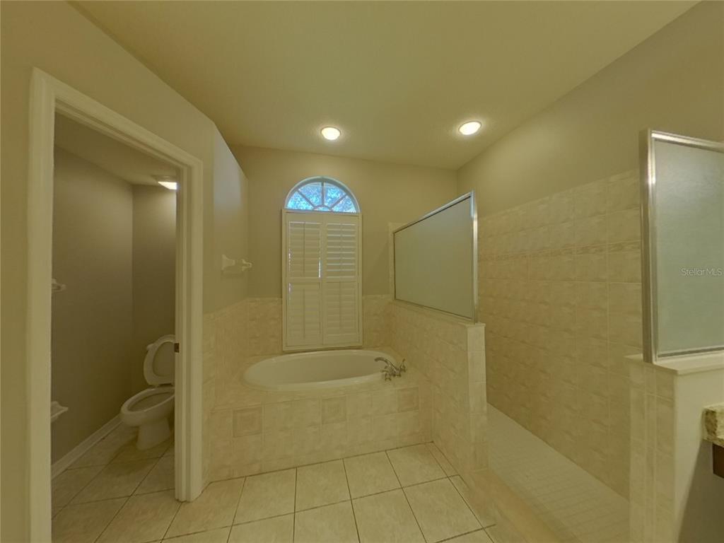 Undisclosed Address Valrico, FL 33596 - Photo 8 of 16 a bathroom with a shower and a toilet