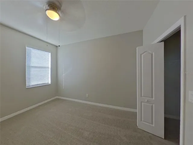 an empty room with windows and closet