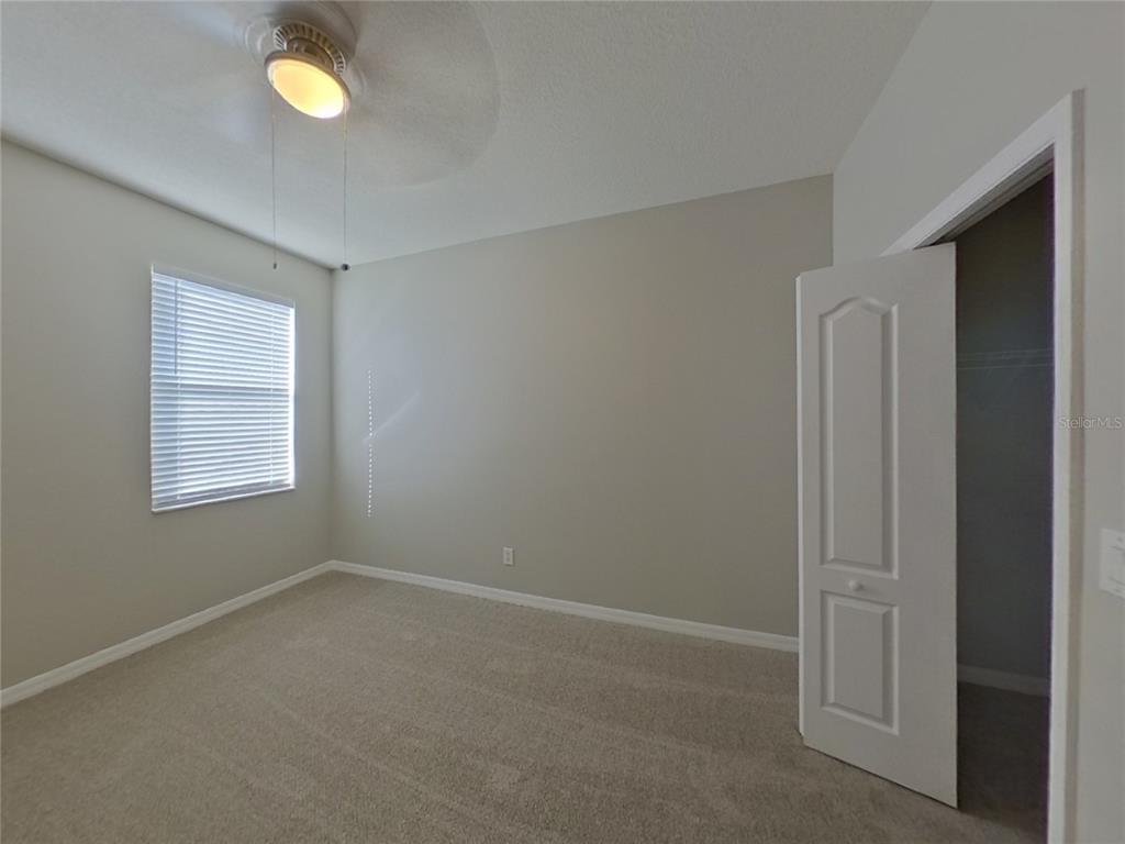 Undisclosed Address Valrico, FL 33596 - Photo 10 of 16 an empty room with windows and closet