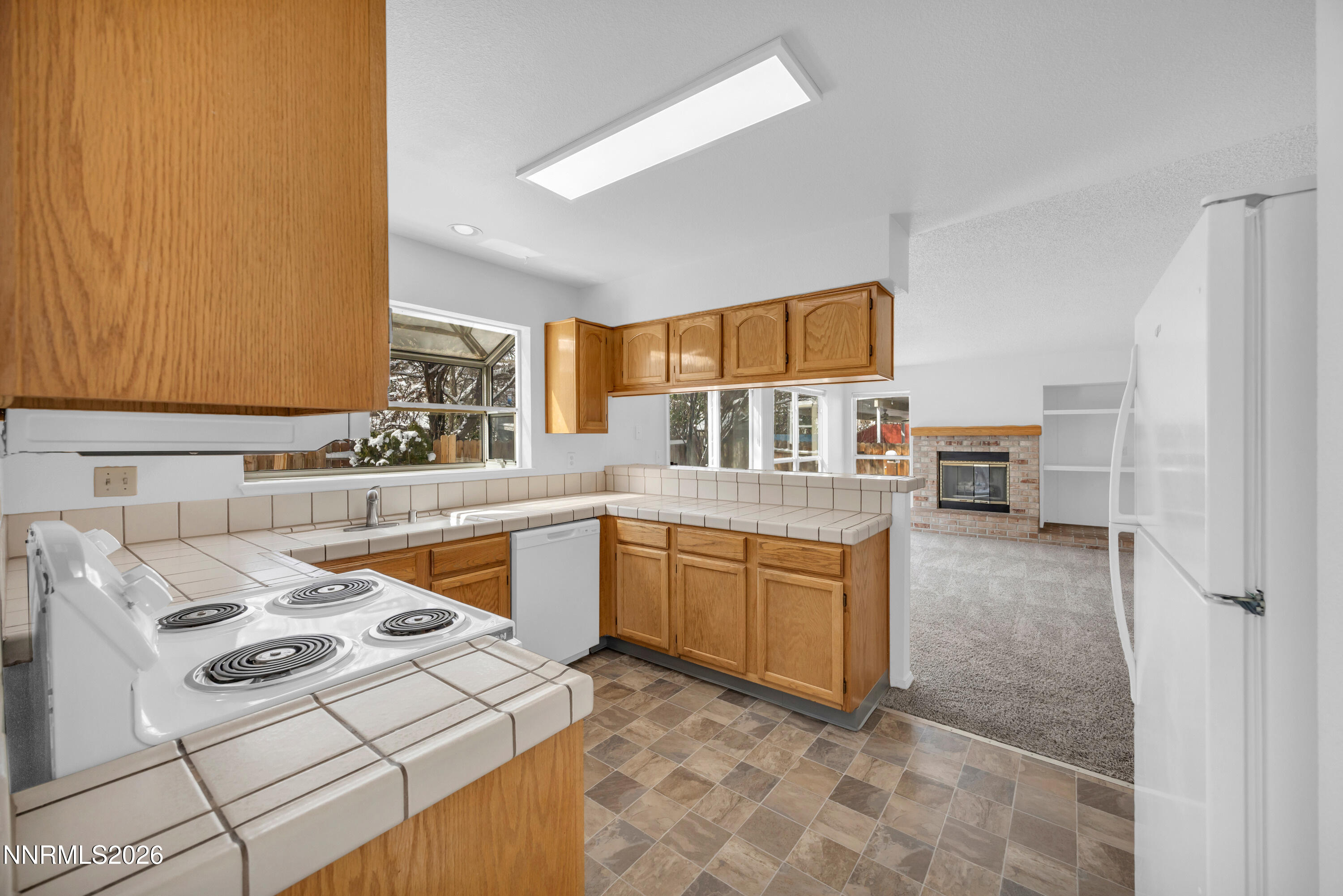 4628 Windcrest Drive Reno, NV 89523 - Photo 12 of 38 a kitchen with stainless steel appliances granite countertop a sink stove and refrigerator