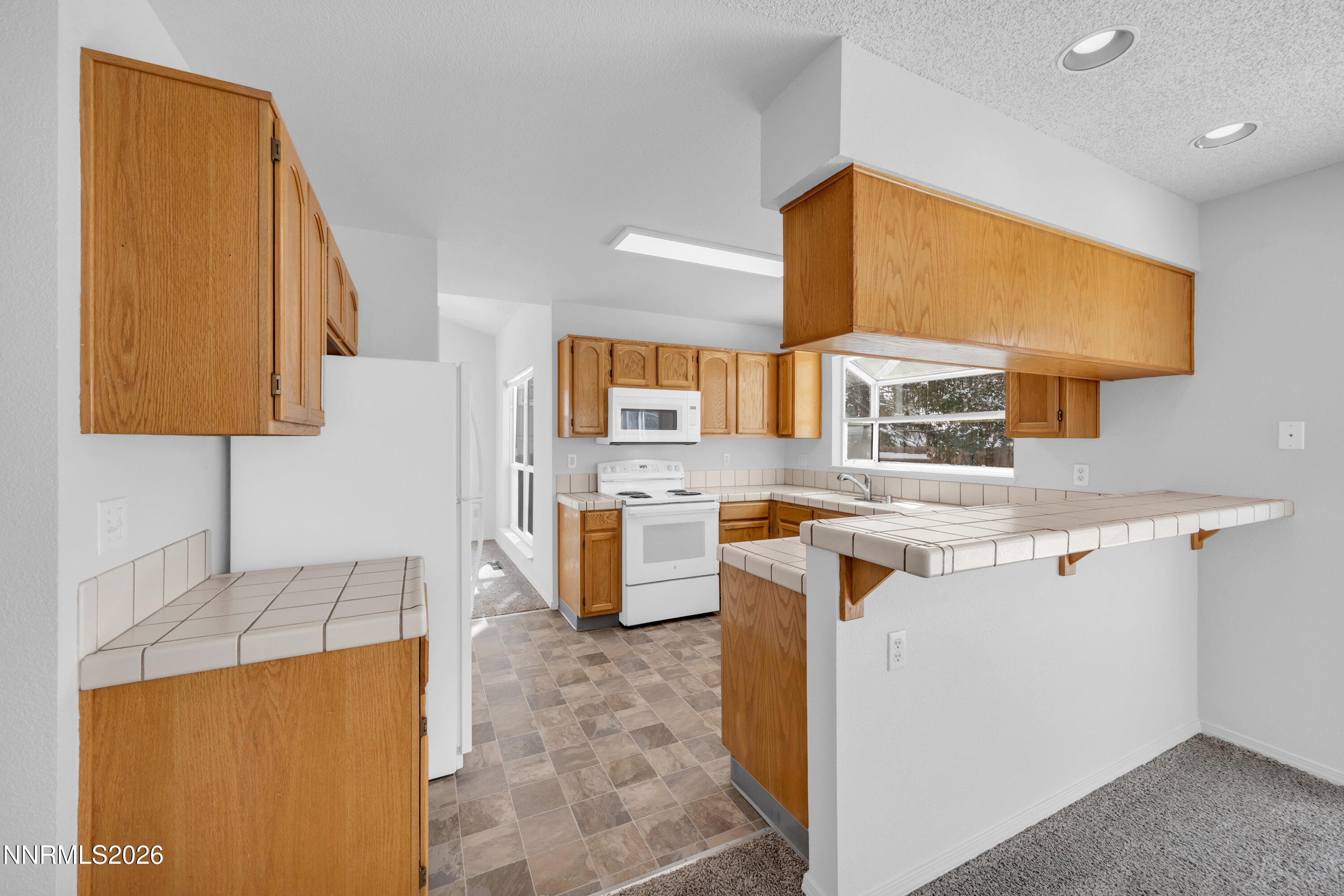 4628 Windcrest Drive Reno, NV 89523 - Photo 14 of 38 a kitchen with stainless steel appliances granite countertop a sink and a stove