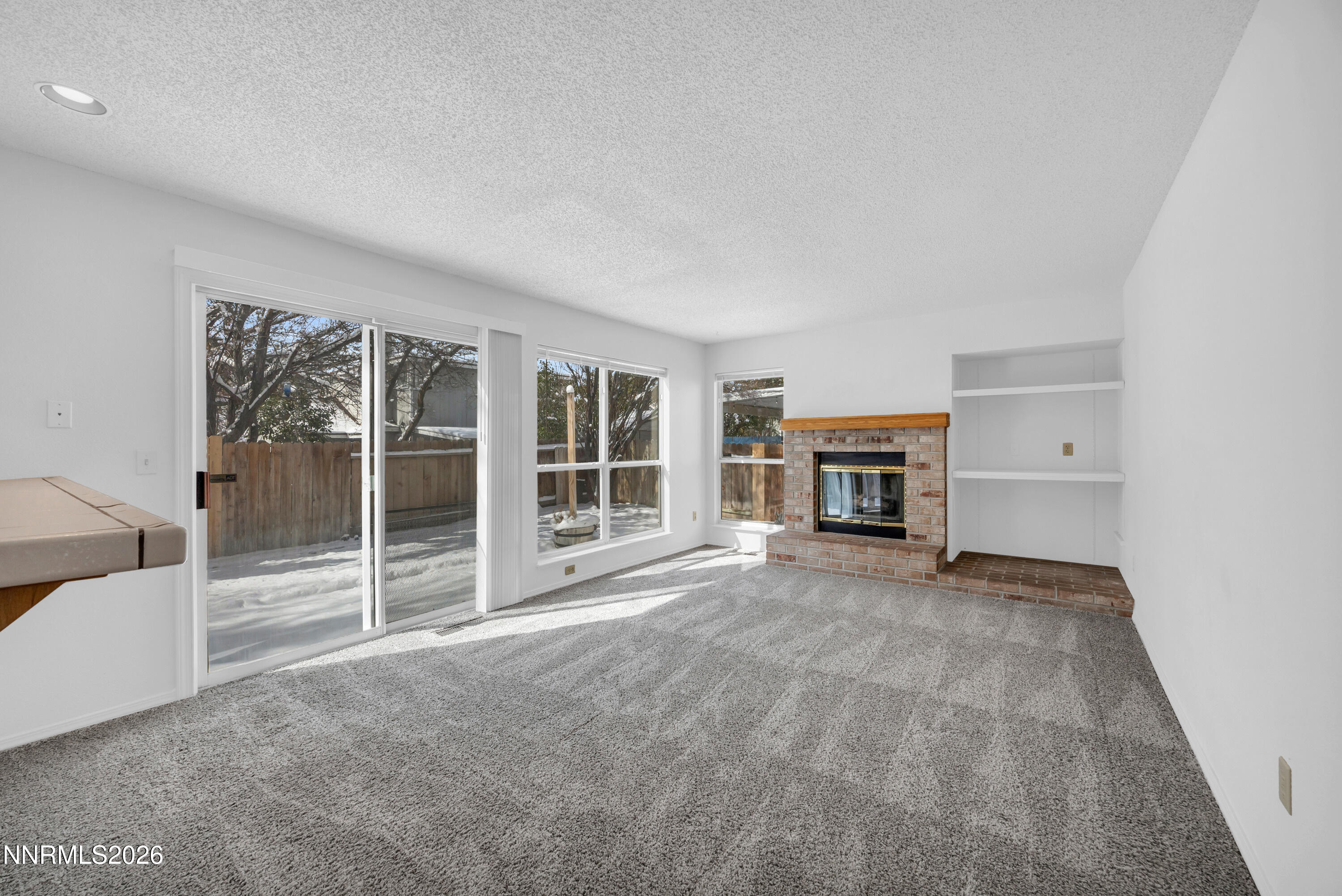 4628 Windcrest Drive Reno, NV 89523 - Photo 16 of 38 an empty room with furniture and a fireplace