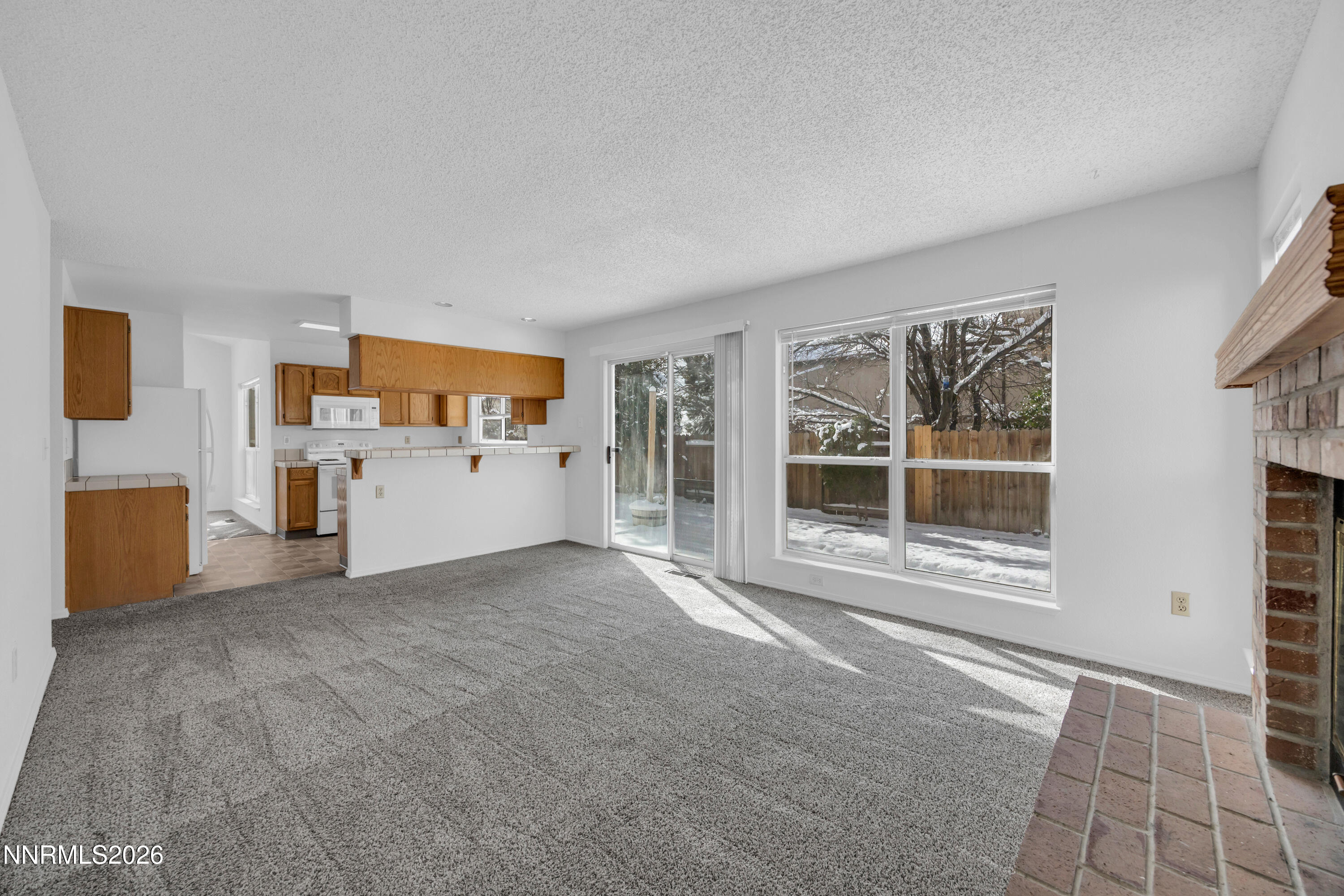 4628 Windcrest Drive Reno, NV 89523 - Photo 17 of 38 a view of an empty room with a kitchen