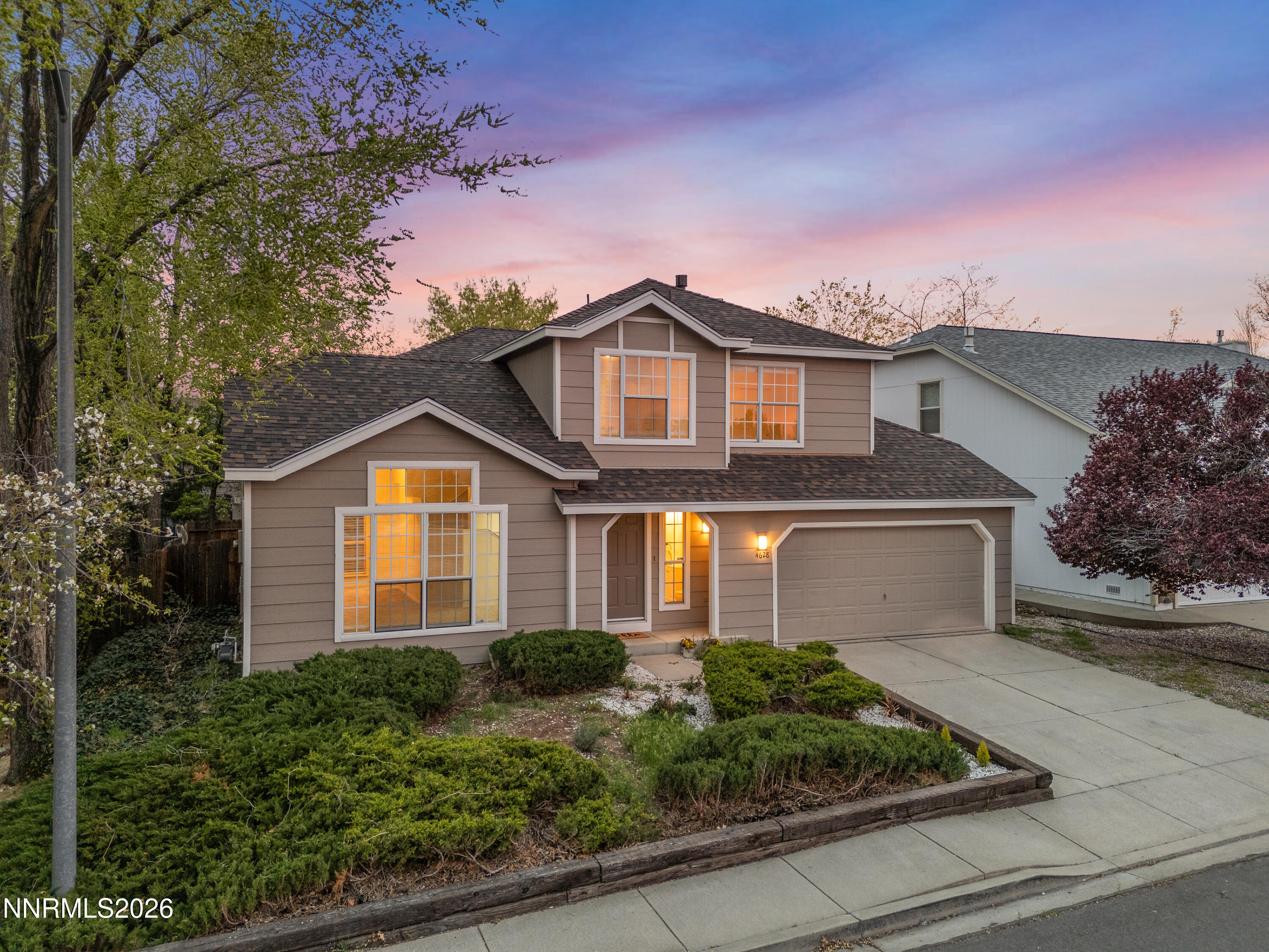 4628 Windcrest Drive Reno, NV 89523 - Photo 2 of 38 a front view of a house with garage and plants