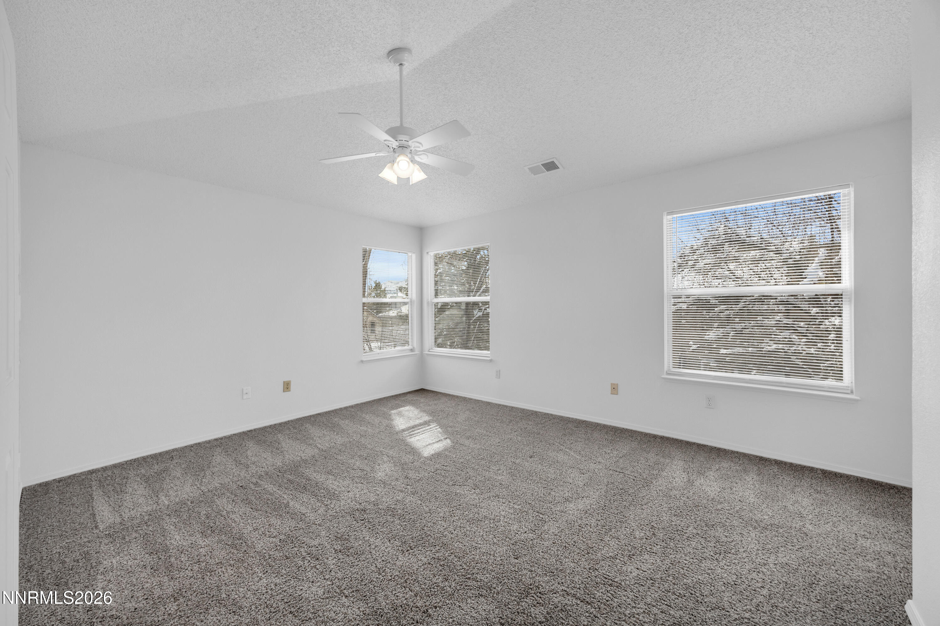 4628 Windcrest Drive Reno, NV 89523 - Photo 21 of 38 an empty room with windows and ceiling fan