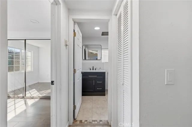 a bathroom with a sink toilet a mirror and shower curtain