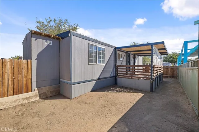 a view of a house with wooden fence