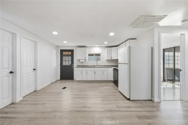 a view of a kitchen with wooden floor