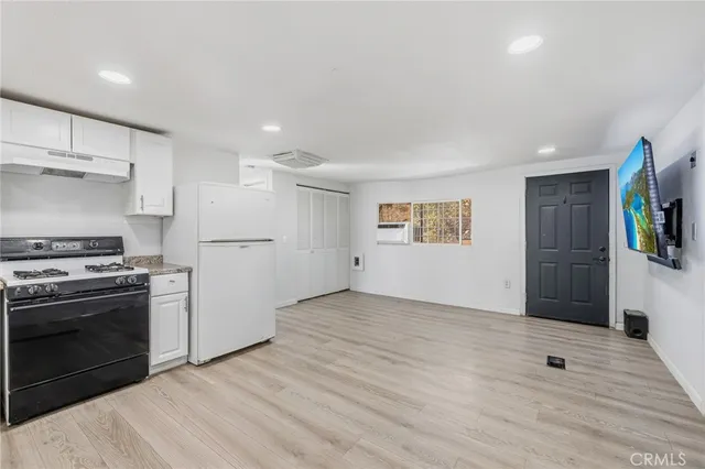 a view of a kitchen with a stove cabinets and wooden floor
