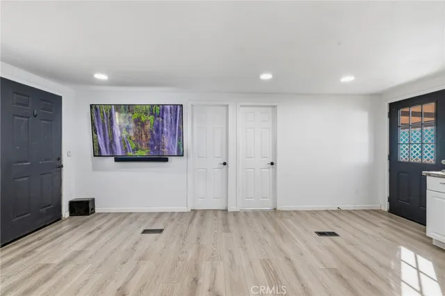 a view of a room with wooden floor and window
