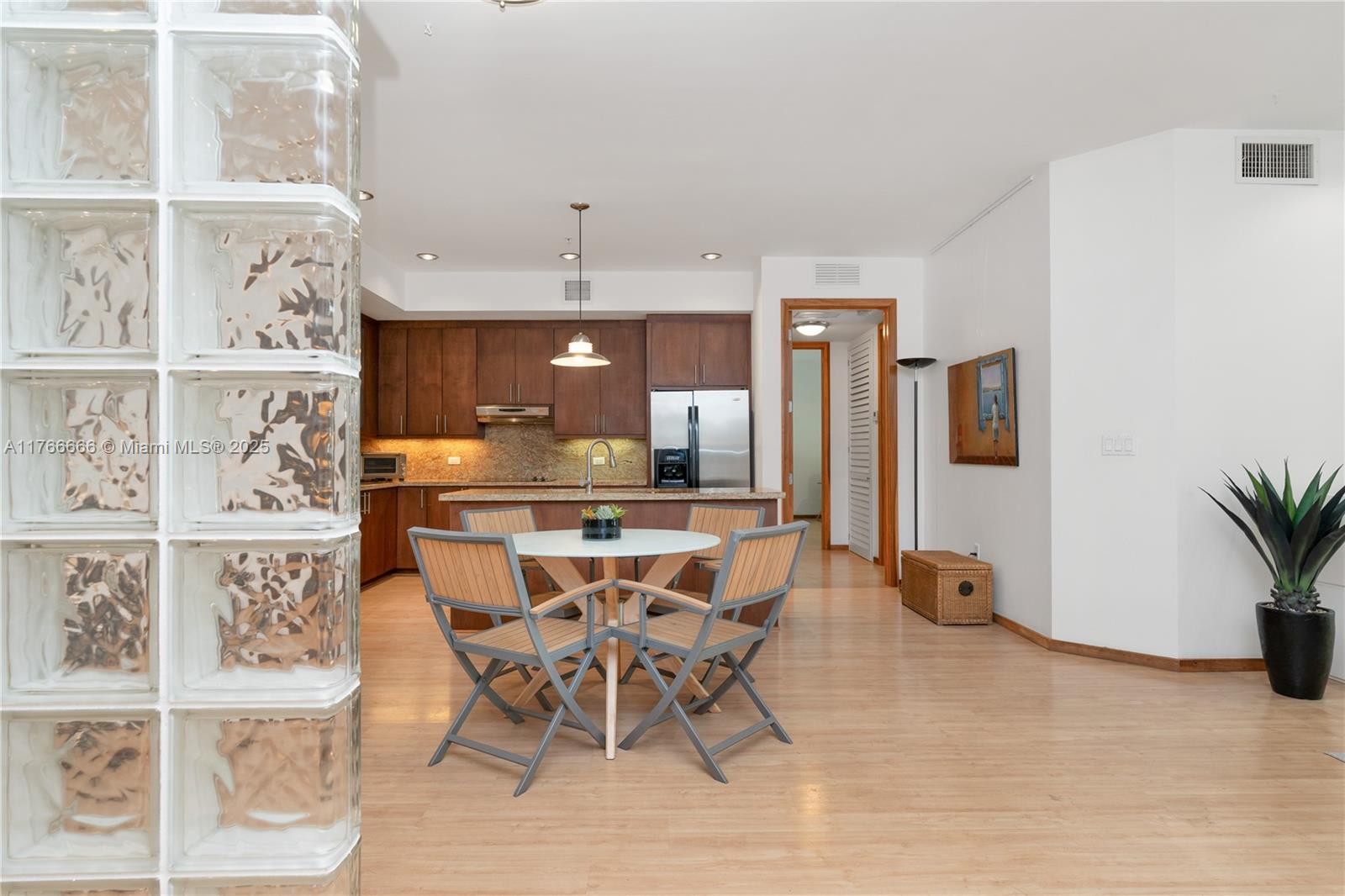 3333 Rice Street, Unit 202 Miami, FL 33133 - Photo 11 of 36 a view of a dining room with furniture and a floor to ceiling window