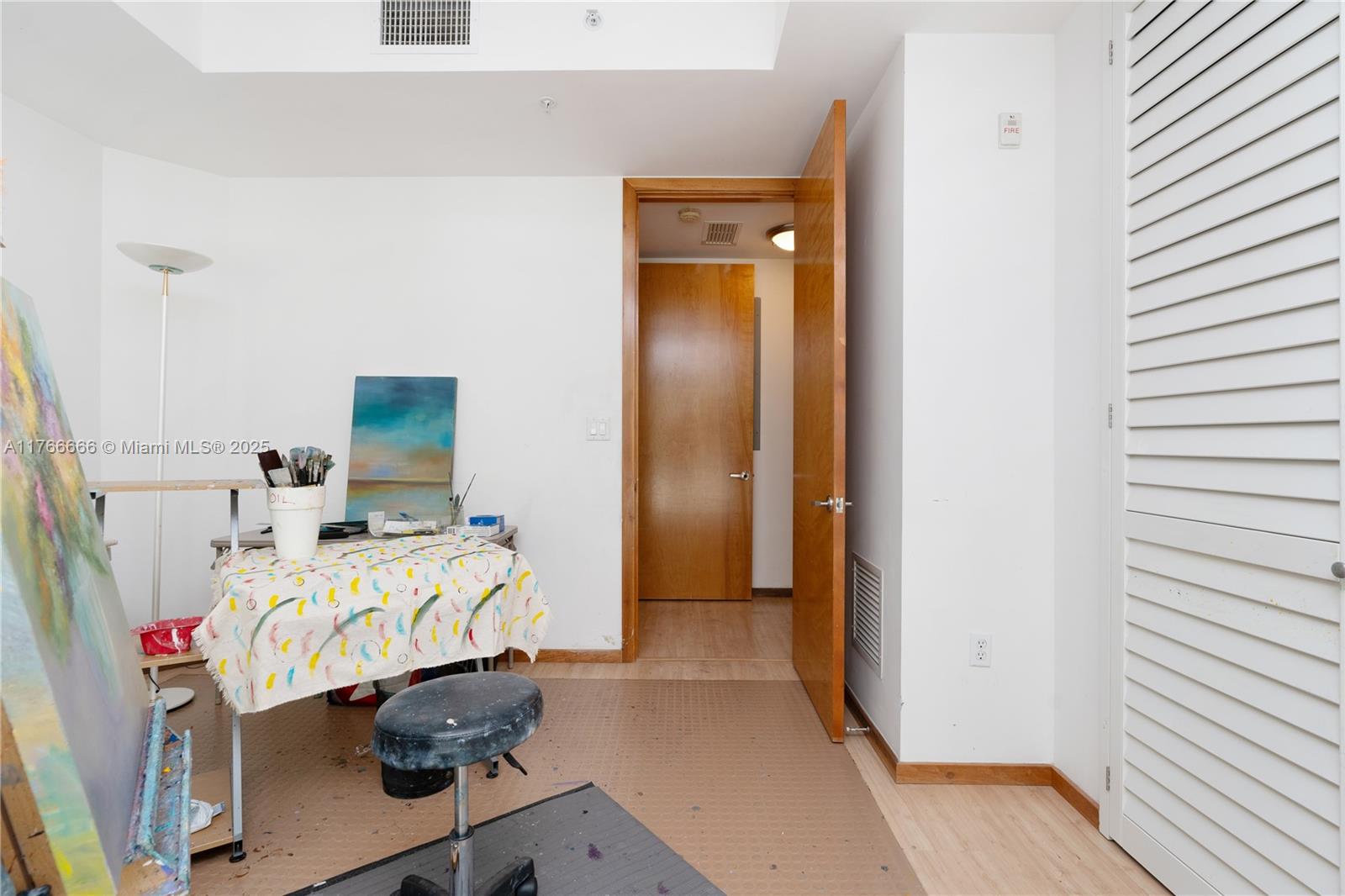 3333 Rice Street, Unit 202 Miami, FL 33133 - Photo 21 of 36 a bedroom with a bed and a desk