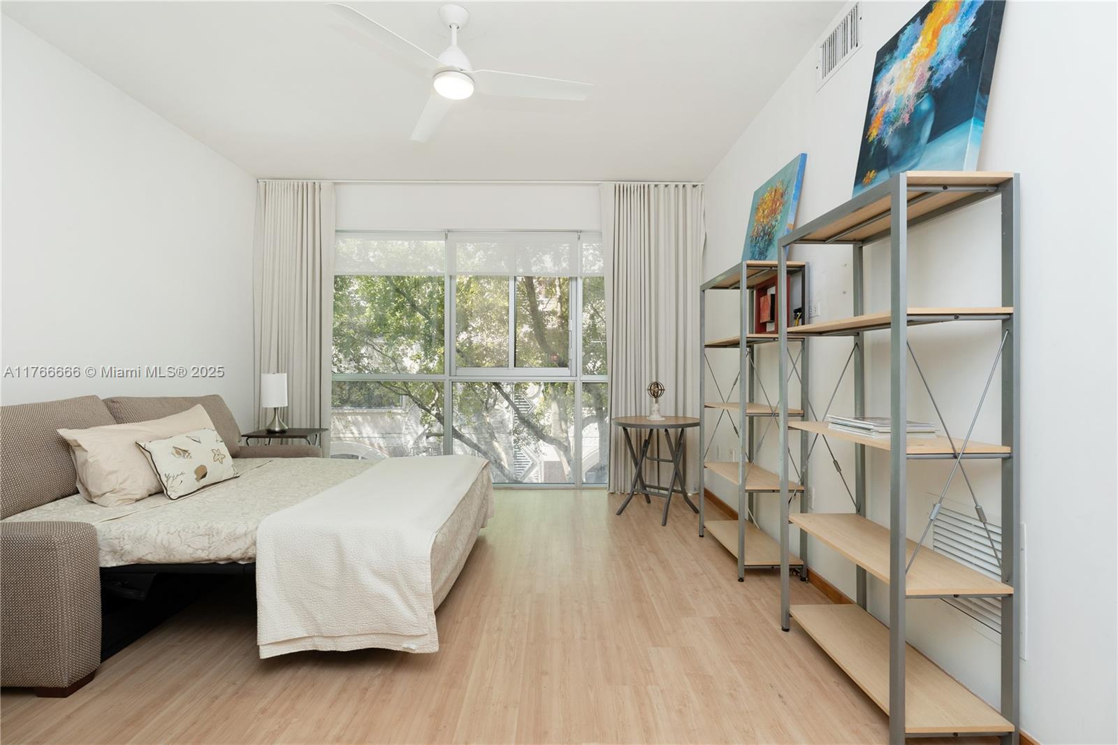 3333 Rice Street, Unit 202 Miami, FL 33133 - Photo 23 of 36 a bedroom with furniture and a large window