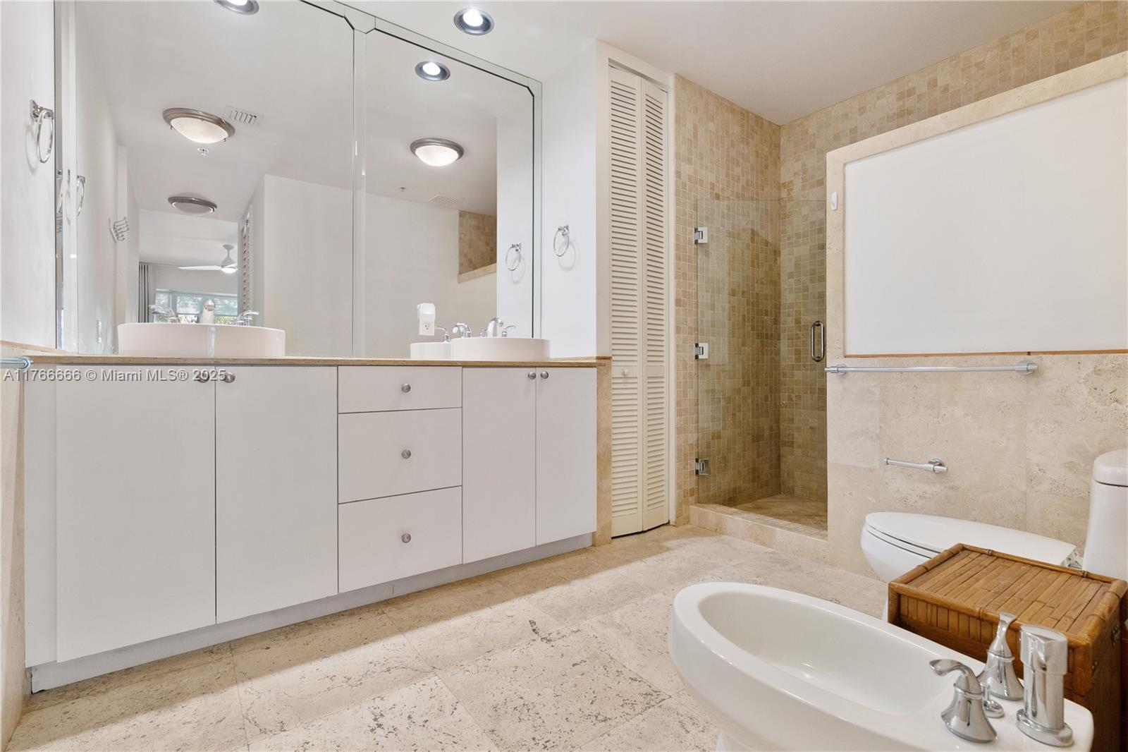 3333 Rice Street, Unit 202 Miami, FL 33133 - Photo 25 of 36 a bathroom with a sink and a mirror