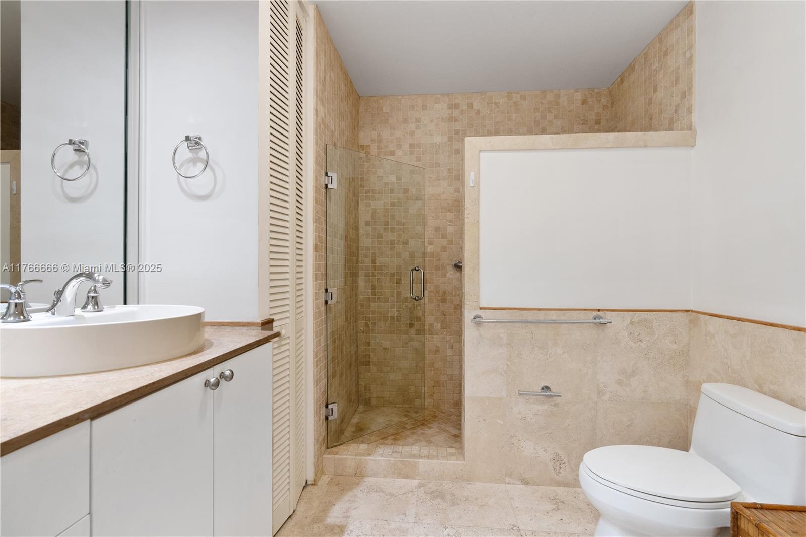 3333 Rice Street, Unit 202 Miami, FL 33133 - Photo 28 of 36 a bathroom with a sink a toilet and shower