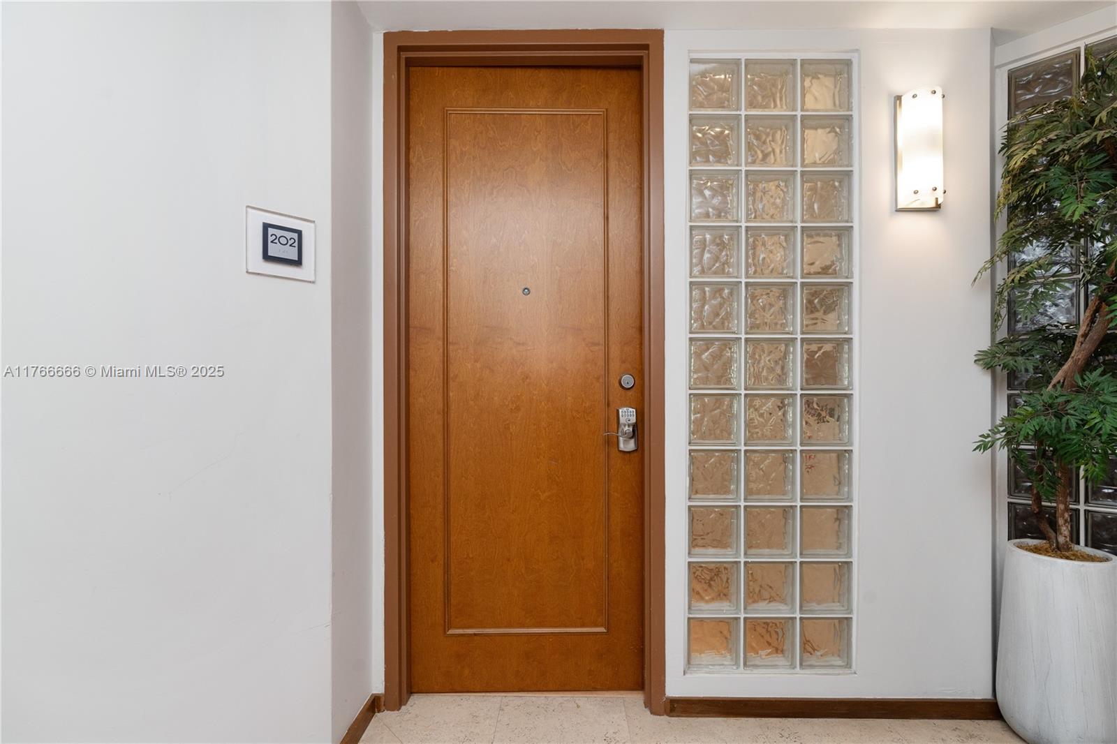 3333 Rice Street, Unit 202 Miami, FL 33133 - Photo 4 of 36 a view of front door with wooden door