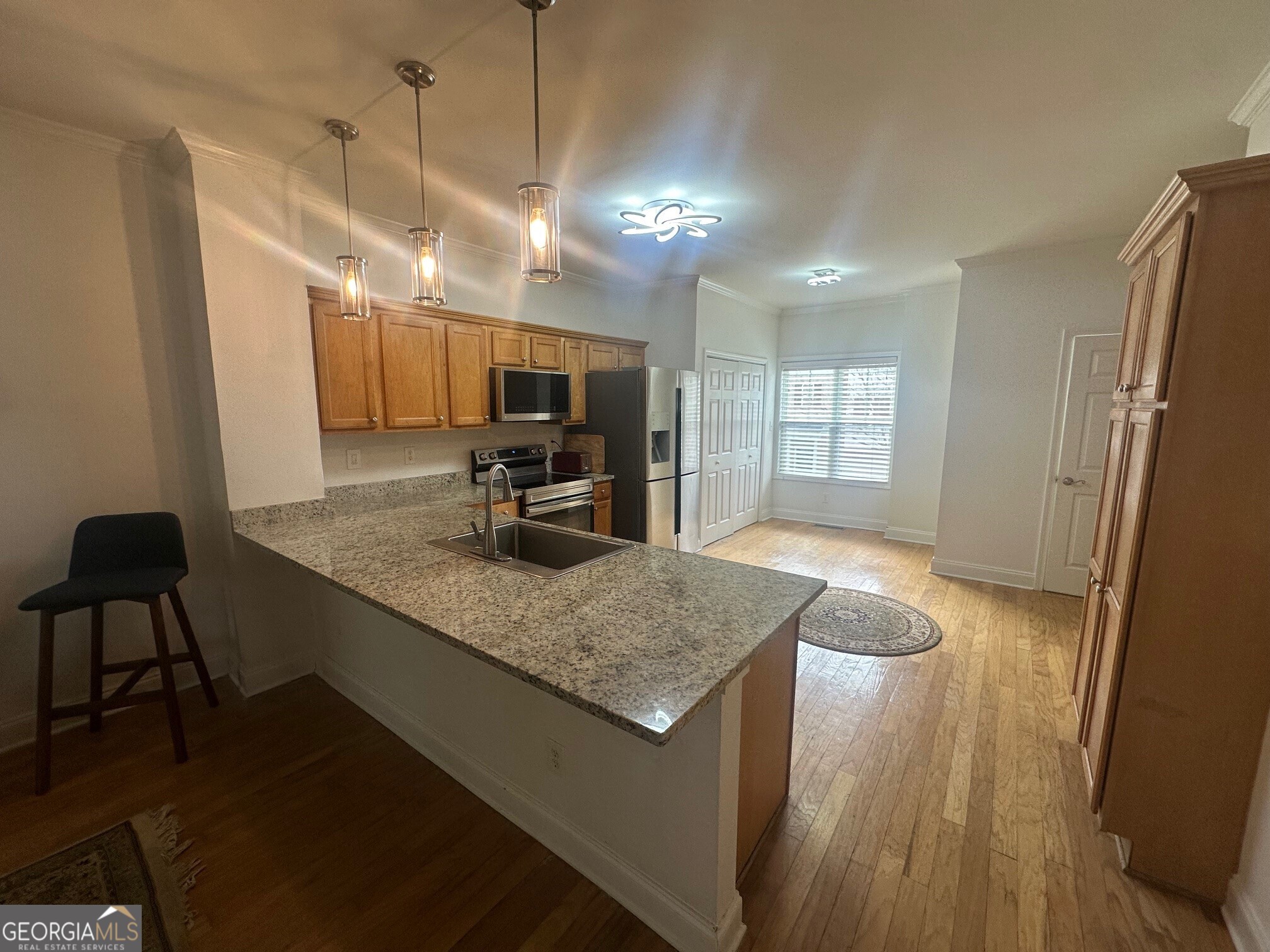3060 Lauren Parc Road Decatur, GA 30032 - Photo 17 of 34 a kitchen with kitchen island a counter top space a sink stainless steel appliances and cabinets