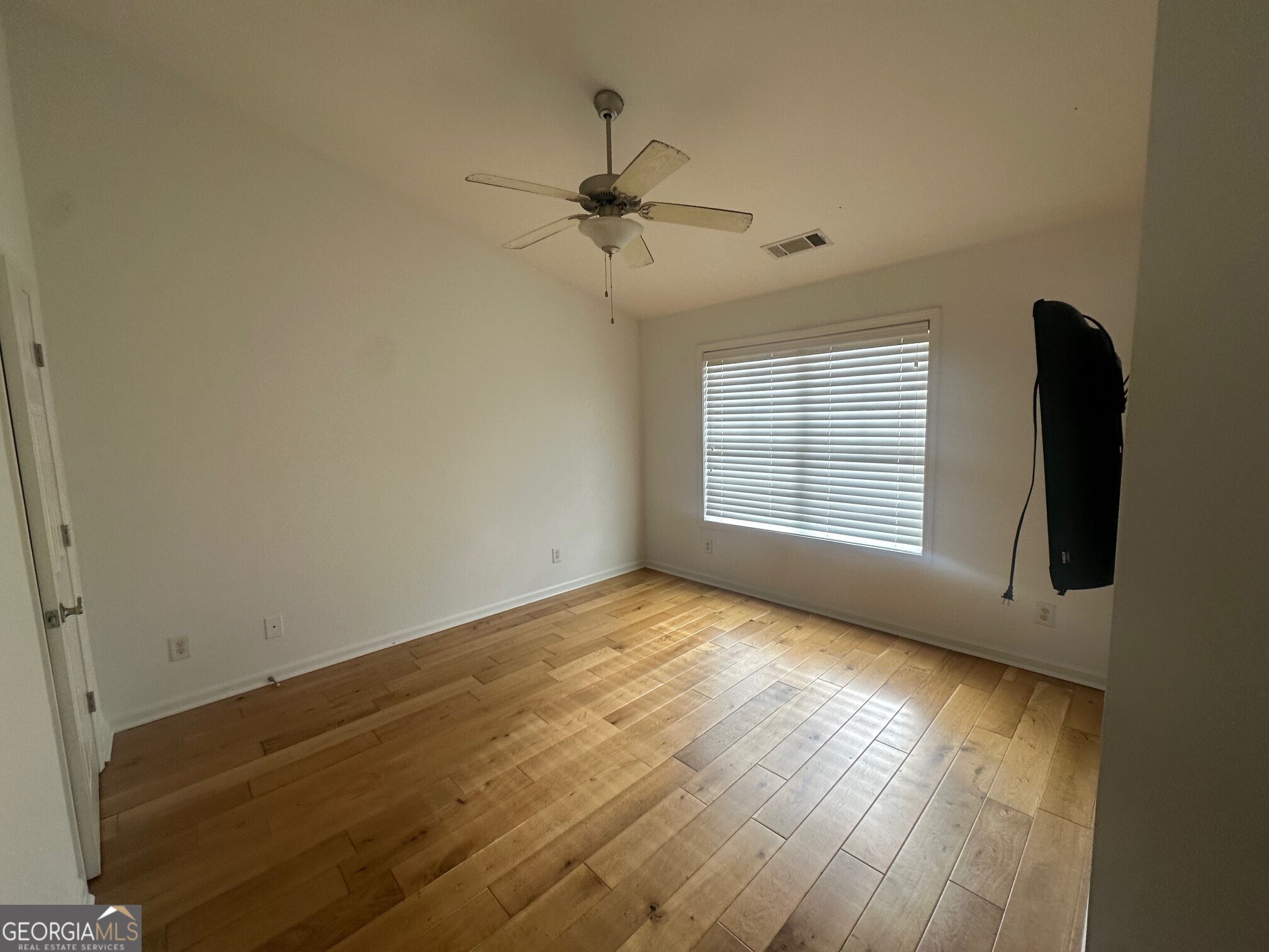 3060 Lauren Parc Road Decatur, GA 30032 - Photo 25 of 34 an empty room with wooden floor ceiling fan and windows