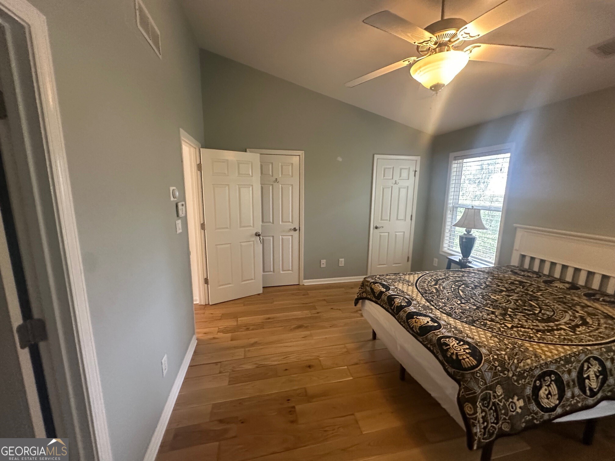 3060 Lauren Parc Road Decatur, GA 30032 - Photo 32 of 34 a bedroom with a bed and a chandelier