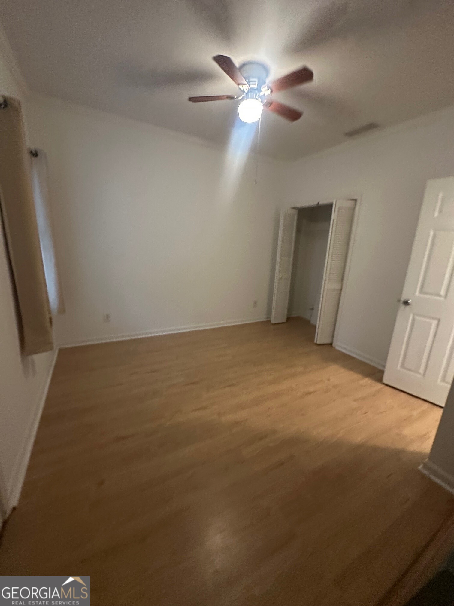 3060 Lauren Parc Road Decatur, GA 30032 - Photo 6 of 34 en empty room with windows and fan