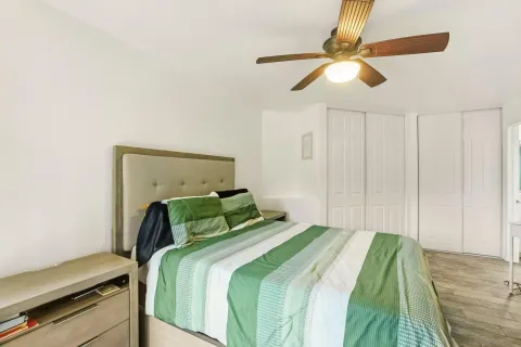 a bedroom with a bed and a ceiling fan