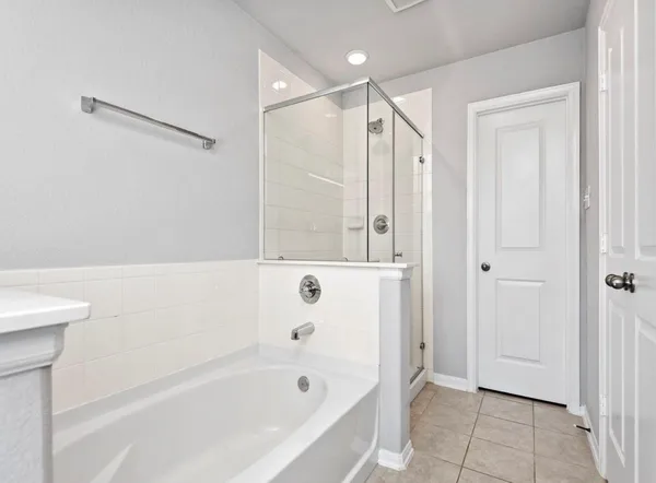 a bathroom with a bathtub shower and a sink