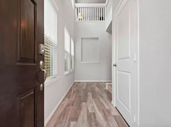 a view of a bedroom with wooden floor and a window