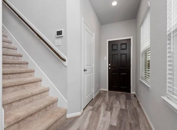 a view of entryway with stairs and wooden floor