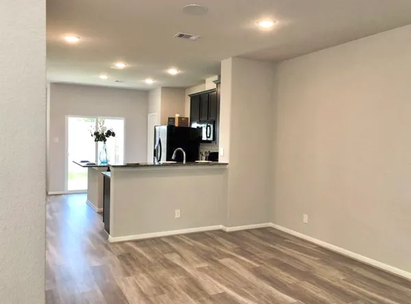 a view of kitchen with microwave and refrigerator
