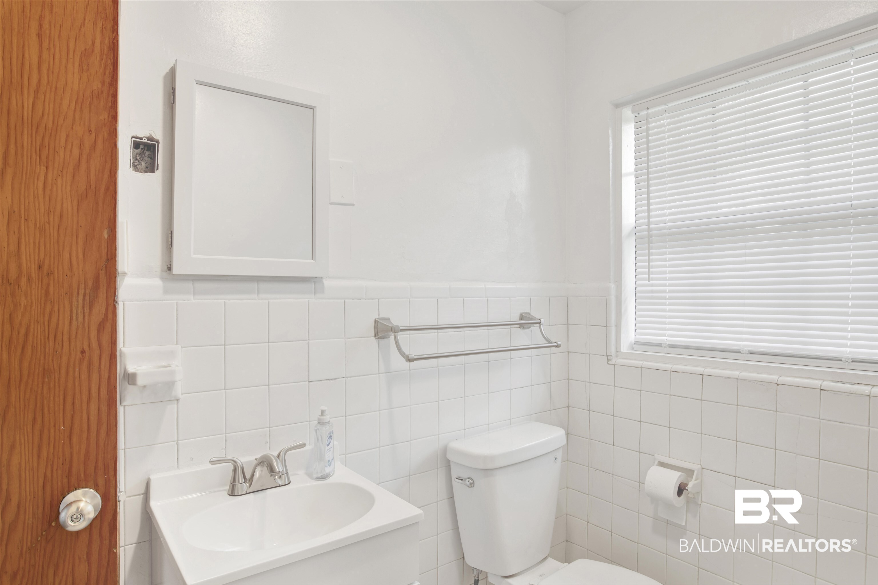 311 West Myrtle Avenue Foley, AL 36535 - Photo 17 of 22 Bathroom featuring vanity, toilet, and tile walls
