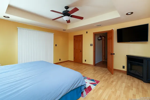 a bedroom with a bed and a flat screen tv