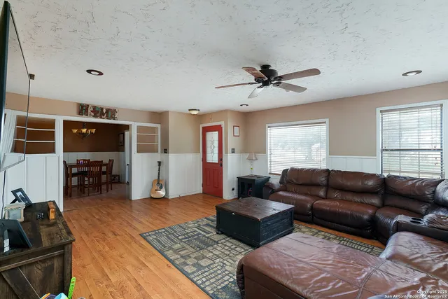 a living room with furniture ceiling fan and a rug