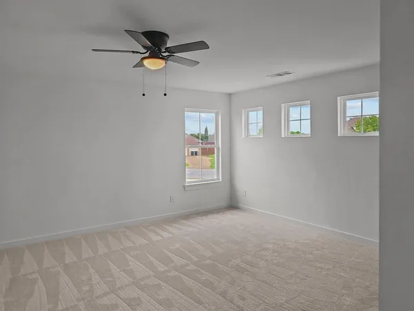a view of empty room with ceiling fan