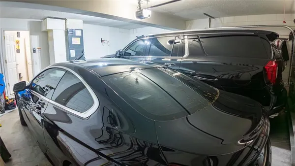 a utility room with two washing machine and racks