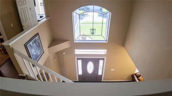 a view of a hallway with wooden floor and stairs