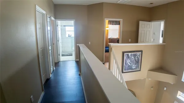 a view of a hallway with a livingroom and a bathroom with sink