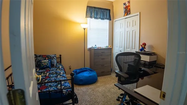a bedroom with furniture and a flat screen tv