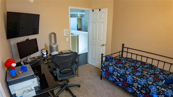 a bedroom with a bed and a flat tv screen