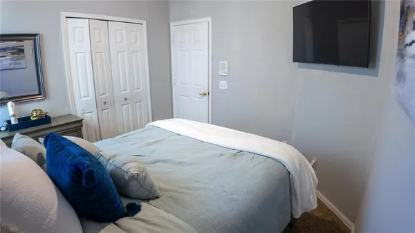 a bedroom with a bed and a chandelier