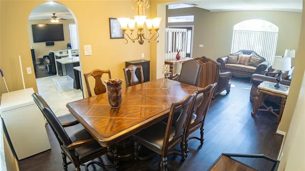 a view of a dining room with furniture and wooden floor