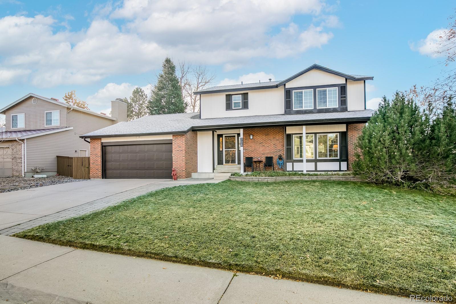 726 Northridge Road Highlands Ranch, CO 80126 - Photo 1 of 40 a front view of a house with a yard and garage