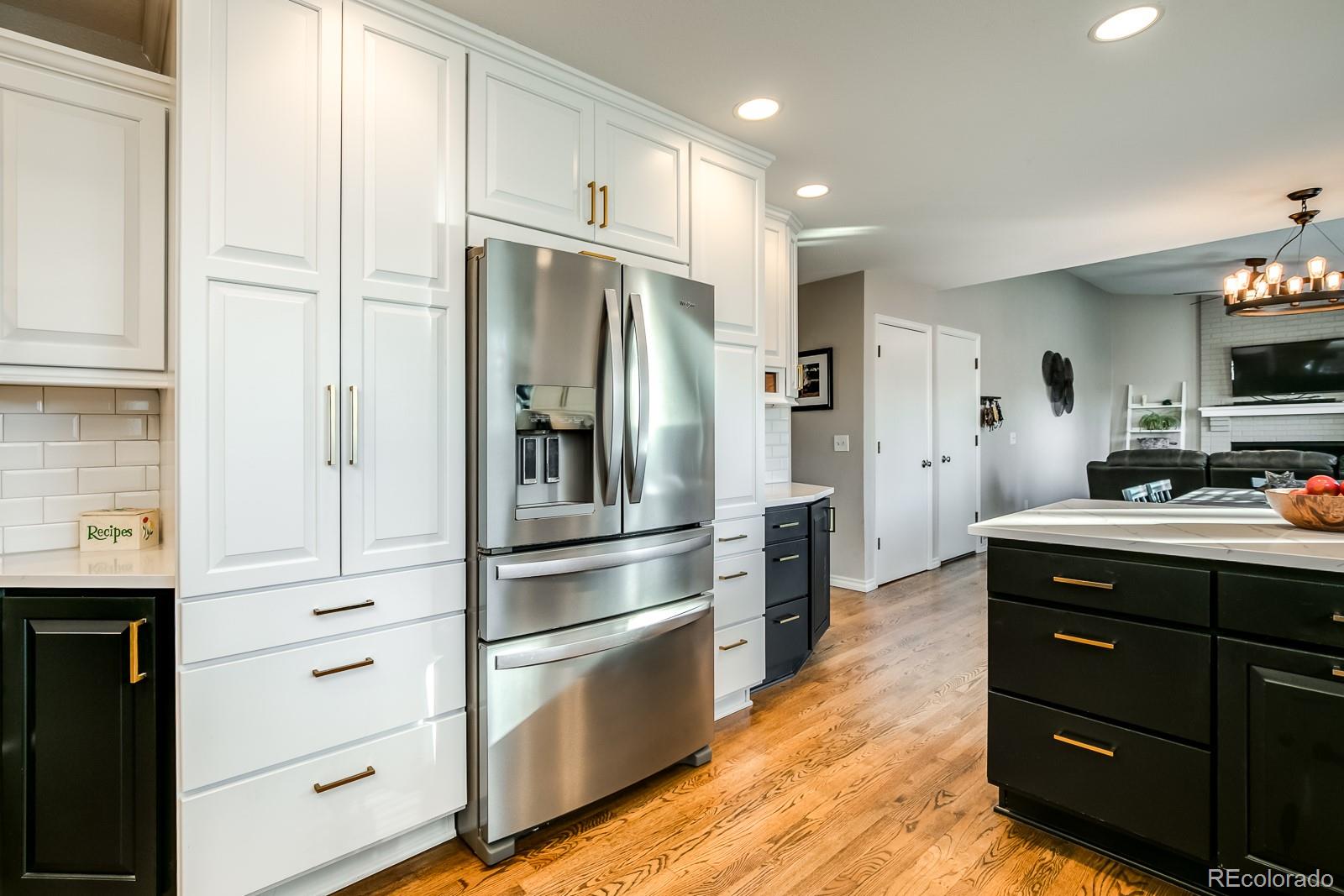 726 Northridge Road Highlands Ranch, CO 80126 - Photo 11 of 40 a kitchen with a refrigerator stove and cabinets