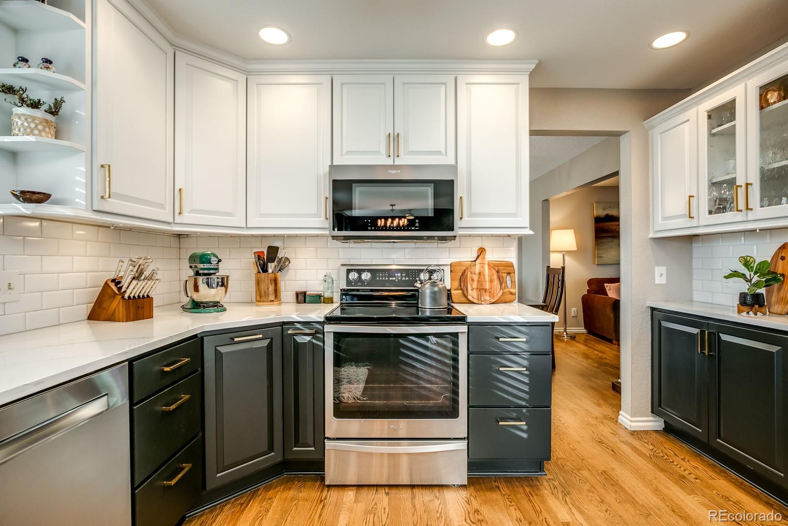 726 Northridge Road Highlands Ranch, CO 80126 - Photo 12 of 40 a kitchen with stainless steel appliances granite countertop a stove sink and cabinets