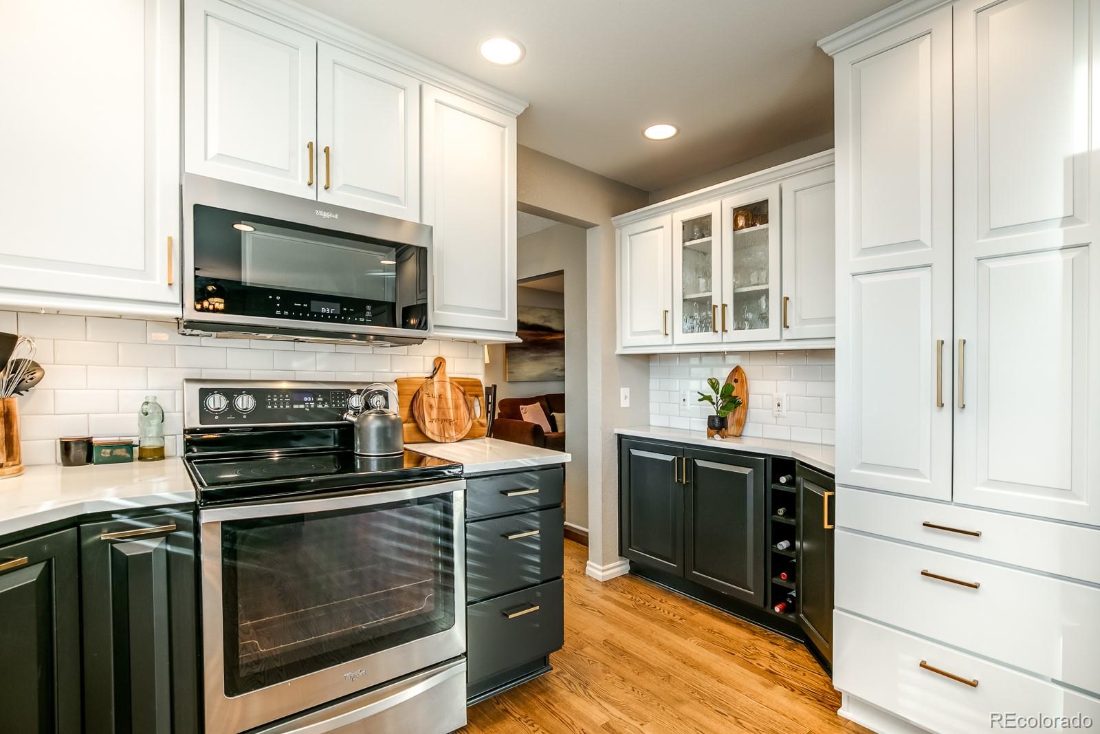 726 Northridge Road Highlands Ranch, CO 80126 - Photo 13 of 40 a kitchen with stainless steel appliances granite countertop a stove top oven a sink dishwasher and cabinets with wooden floor