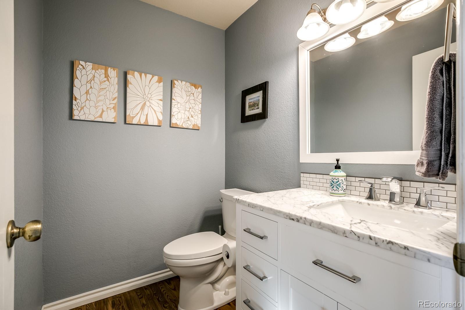 726 Northridge Road Highlands Ranch, CO 80126 - Photo 20 of 40 a bathroom with a granite countertop toilet sink and mirror