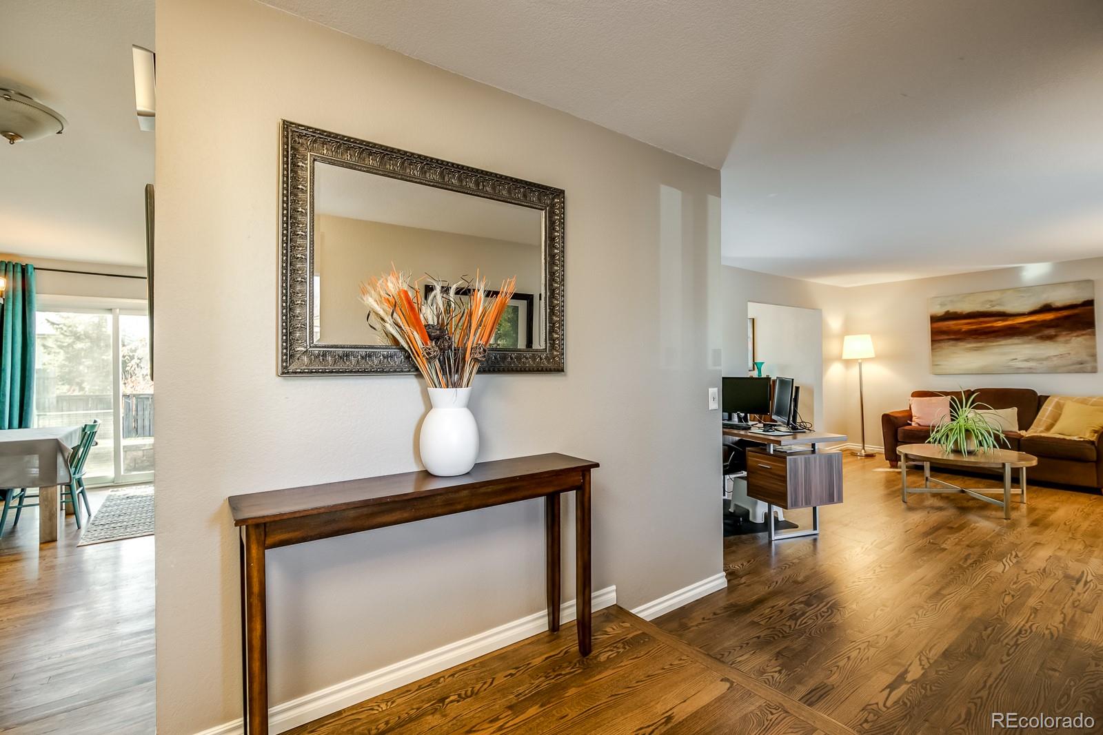 726 Northridge Road Highlands Ranch, CO 80126 - Photo 2 of 40 a living room with furniture and a wooden floor