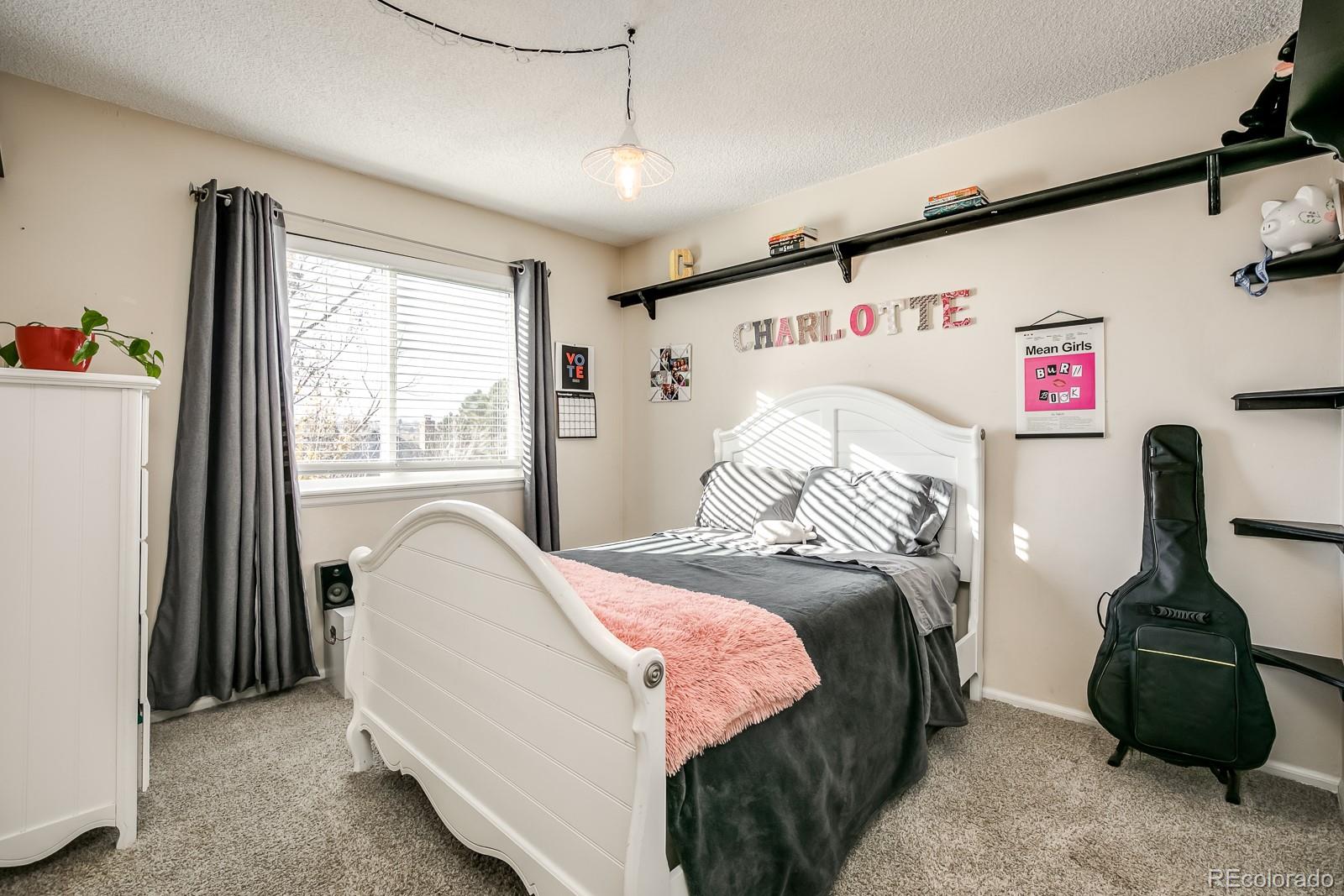 726 Northridge Road Highlands Ranch, CO 80126 - Photo 26 of 40 a bedroom with a bed and a window