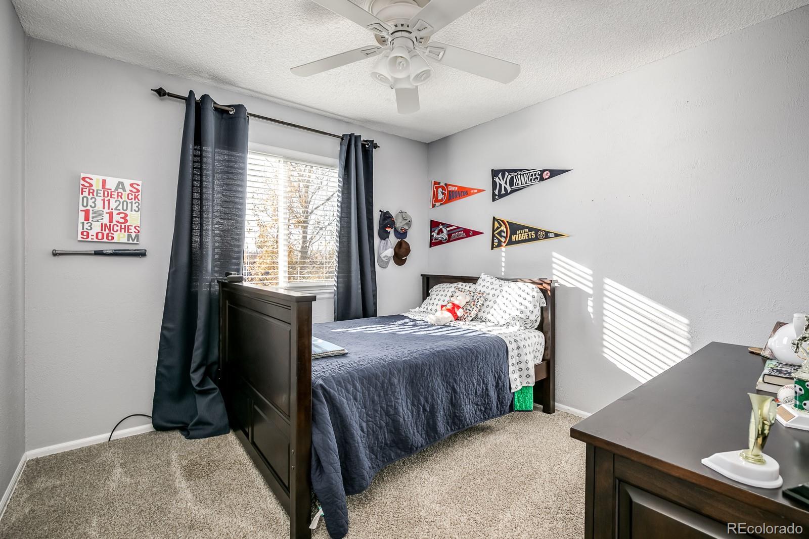 726 Northridge Road Highlands Ranch, CO 80126 - Photo 27 of 40 a bedroom with a bed and a window
