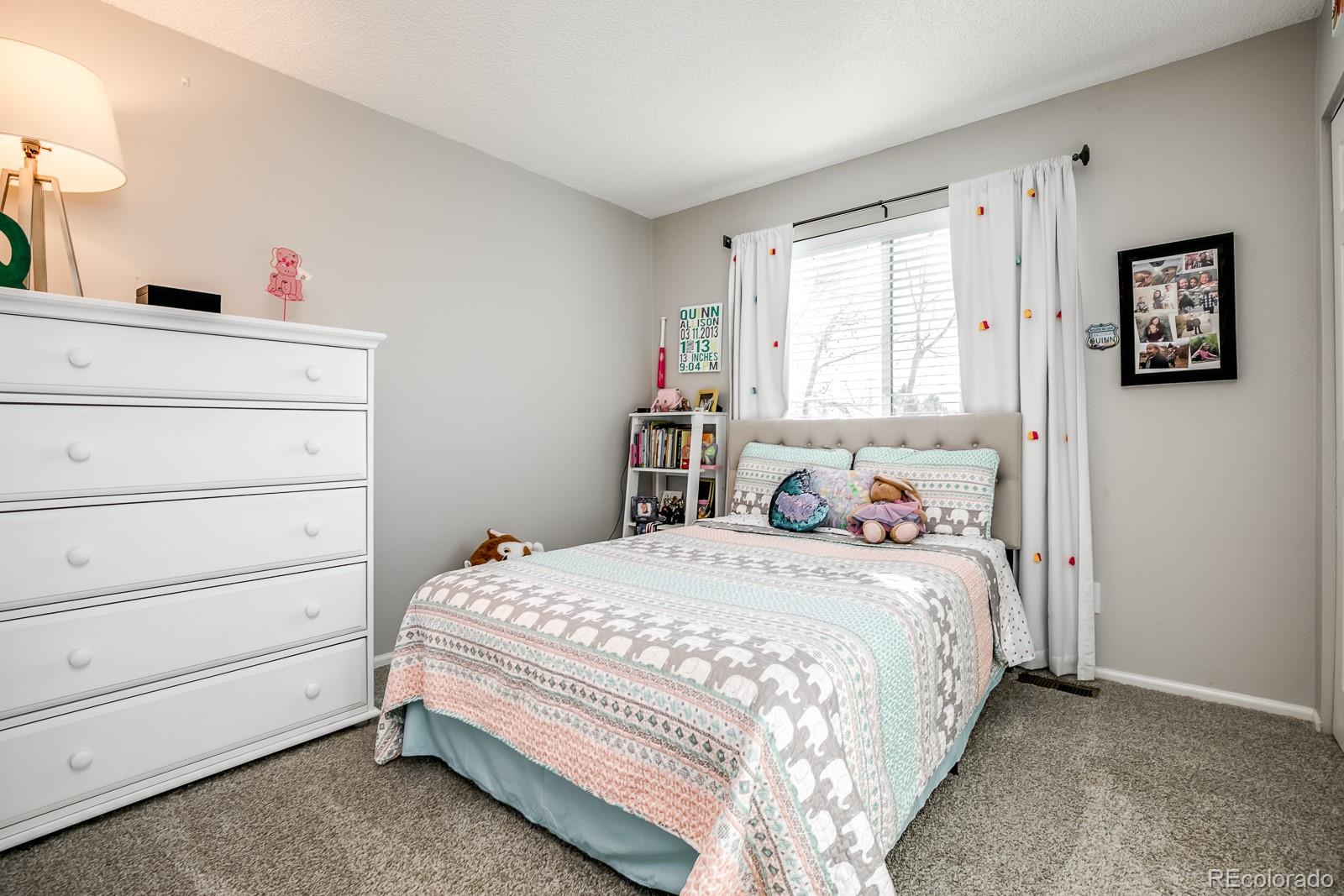 726 Northridge Road Highlands Ranch, CO 80126 - Photo 28 of 40 a bedroom with a bed and a window